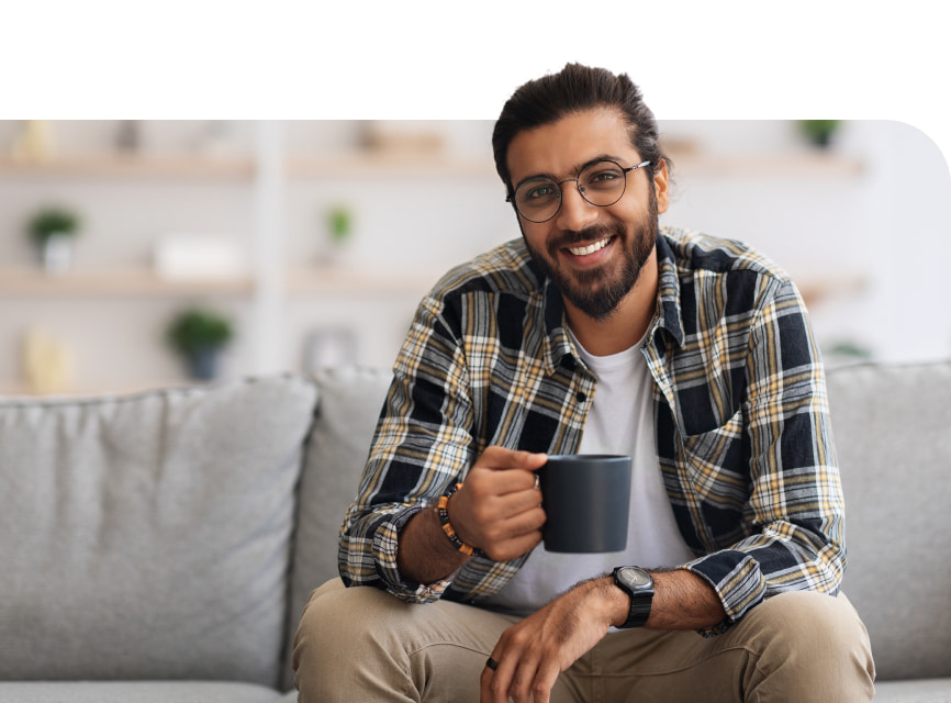 indian man sitting with a cup in his hands