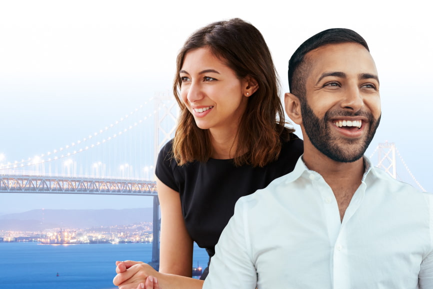 indian man smiling and immigrant woman standing next to each other